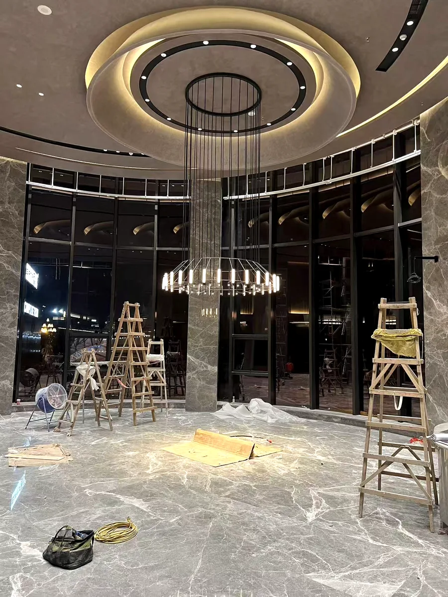 Hotel lobby ring chandelier under installation